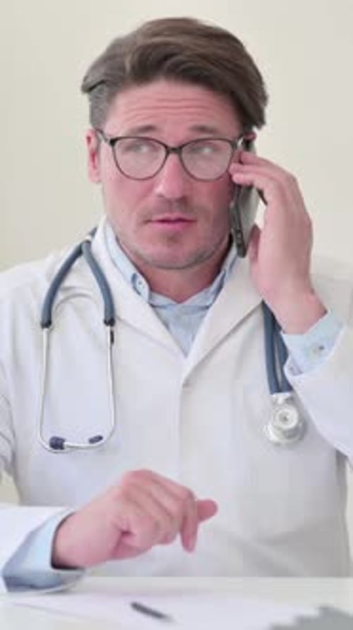 Doctor in White Coat Talking on Mobile Phone