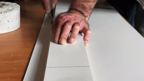 Close up of man cutting board with knife