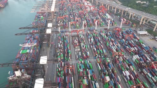 High angle drone panning shot of a busy day at the container terminal in Hong Kong