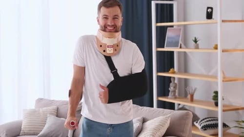 Smiling Man with Arm Sling and Neck Brace