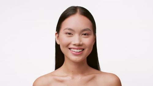 Woman with Dark Hair Smiling in Studio Portrait