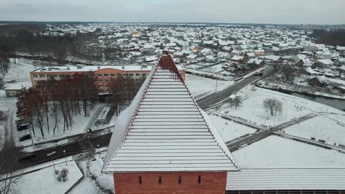 Aerial View of a Historical Fortress with Towers at a Crossroads in the Town and Next to the Lake