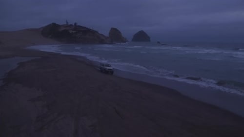 Aerial View of Group of Friends Driving on Beach in Vintage Vehicle Aerial