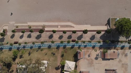 The Camera Flies Along the Beach Over a Wellequipped Blue Jogging Track