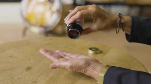 Taking Medication Pills from Bottle Close-up