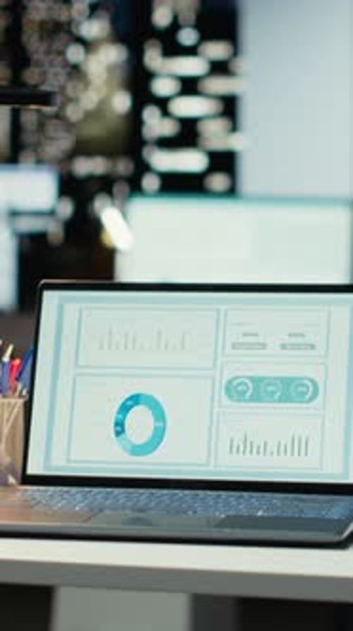 Vertical Video High End Empty Workspace Features Laptop with Data Charts for Forecasting