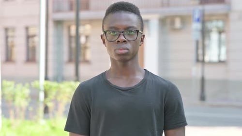 Young Adult Posing Outdoors During the Day