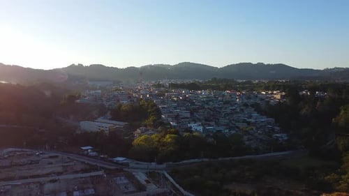 Aerial View of Town Nestled Among Mountains at Sunrise