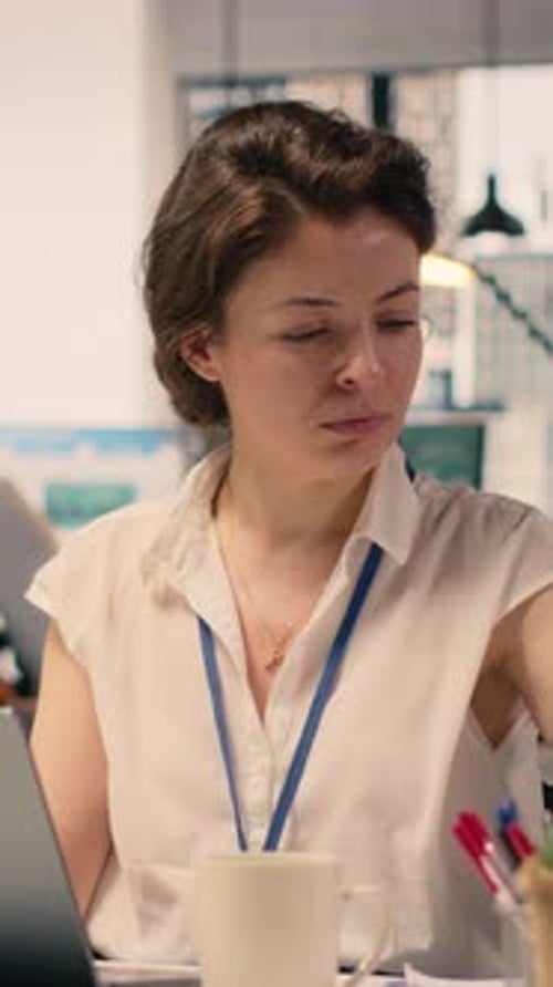 Businesswoman at Desk Studying KPI Metrics and Data Analysis in Office