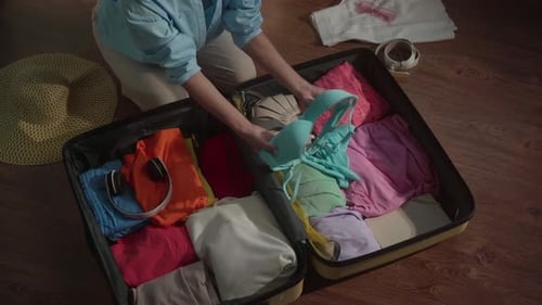 Woman Packing Suitcase for Summer Vacation