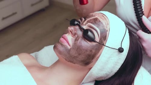 Woman Receives Laser Facial Treatment at Spa