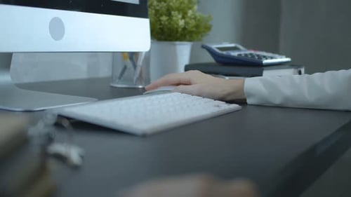 Close Up of Hand Using Computer Mouse