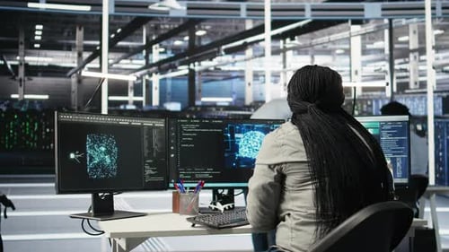 Woman Analyzes Technology Data in Workplace