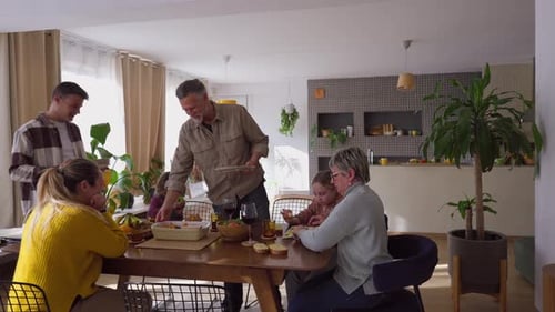 Family Enjoys Meal at Home Around Table