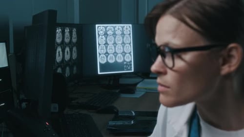 Woman doctor analyzes brain scans in a hospital office