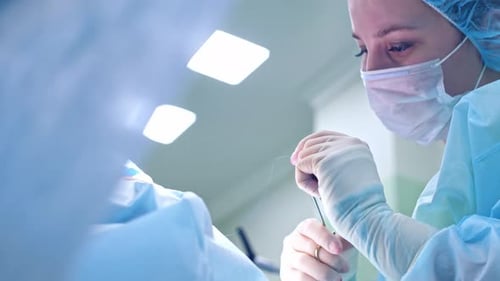 Surgeon Performing Operation in Brightly Lit Room