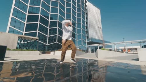Young And Stylish Male Dancer Is Practicing Hip Hop Choreography On Urban Street. Professional Str