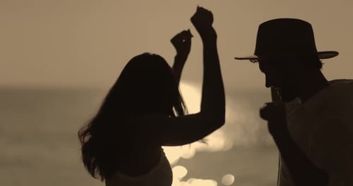 Romantic Couple Dancing at Sunset on Beach in Silhouette