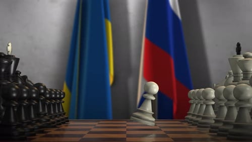 Ukraine and Russia Flags with Chess Pawns for Conflict Symbolism