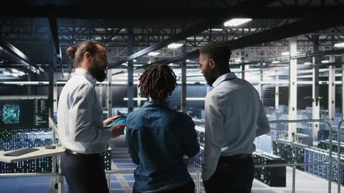 Data Center Manager Talking with Workers Doing Maintenance on AI Supercomputers
