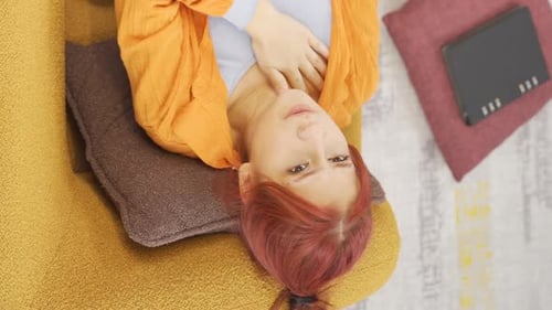 Woman Experiencing Chest and Stomach Pain on Couch