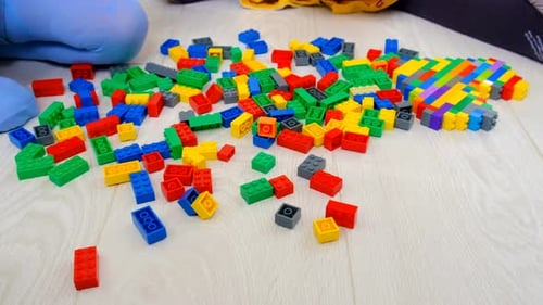 Children Play with Colorful Building Blocks on Floor