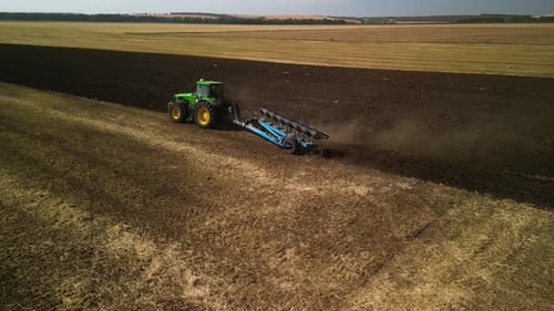 Tractors plowing the field in Ukraine