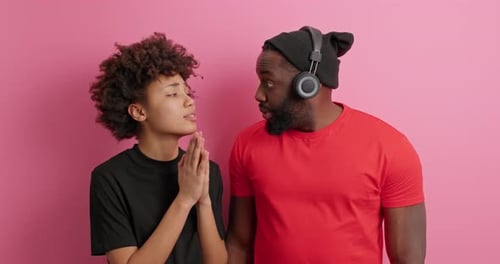 Teen and adult posing in front of pink background