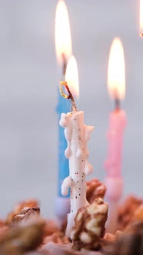Festive Candles Burning Brightly on Birthday Cake