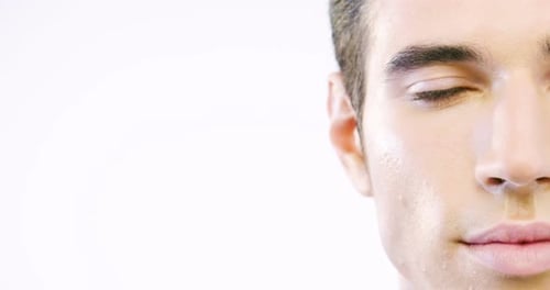 Portrait of a beautiful smiling man showing white teeth looking into camera or making faces of dou