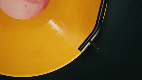 Yellow Vinyl Record Spinning on a Turntable
