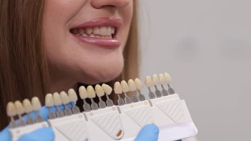 Woman Smiles, Dental Shade Matching in Clinic