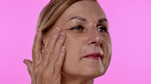 Thoughtful Mature Woman with Hand on Face Close Up