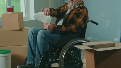 Man in Wheelchair Choosing Paint Colors in New Home
