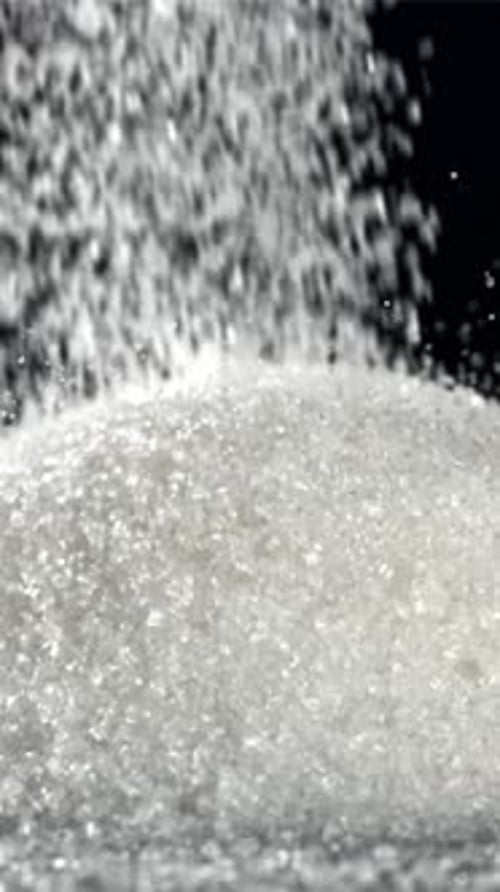Sugar Falls on the Table in a Heap Filmed on a Highspeed Camera at 1000 Fps