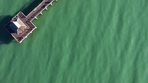 Naples Florida pier at sunset shimmers with luxury homes and turquoise water