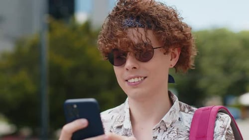 Young Adult Using Smartphone in City Setting