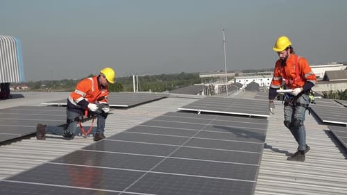 Solar energy and an engineering team on the roof of a building to install panel. Rooftop Solar cell.