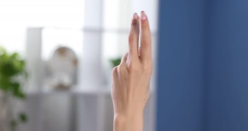 Woman counting on fingers at home, closeup