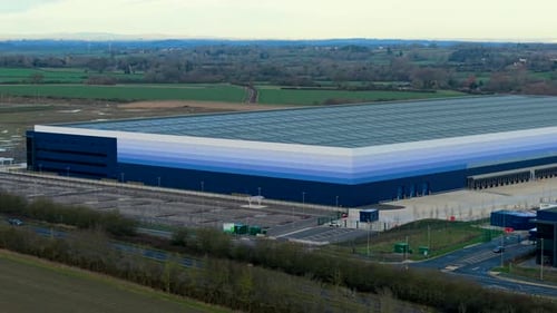 Aerial View of Large Warehouse Complex Operating Logistics Processes Across Rural Industrial Area
