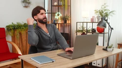 Man Working from Home at Desk on Laptop