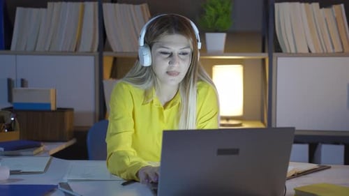 Happy woman working on laptop.