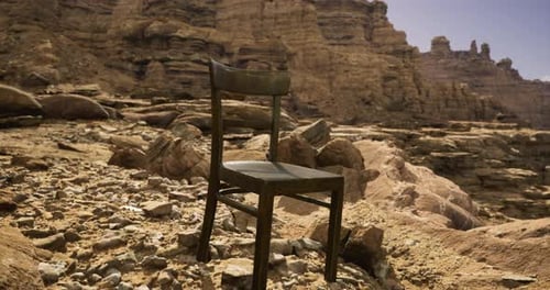 Lonely Chair on Rocky Terrain in a Remote Desert Landscape During Midday