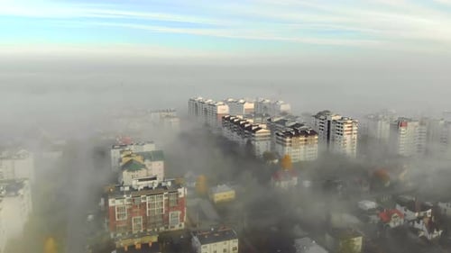 Aerial View at the Houses That are Covered with Morning Fog