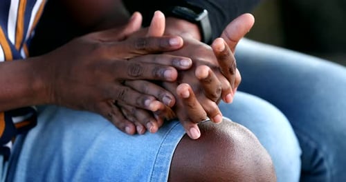 Close-up hands joining together in empathy, people holding hand, African ethnicity