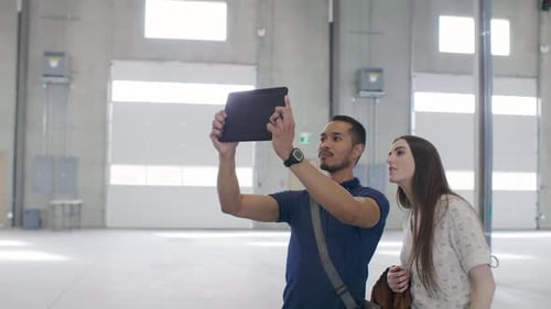 Property Owners with Digital Tablet Photographing Empty Warehouse Adult