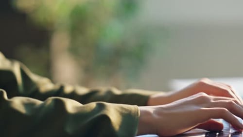 Woman Typing on Laptop Keyboard in Office