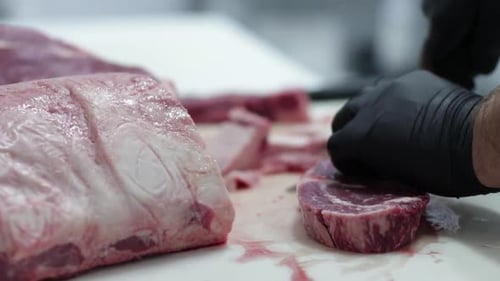 Preparing Delicious Raw Beef Steaks in Restaurant
