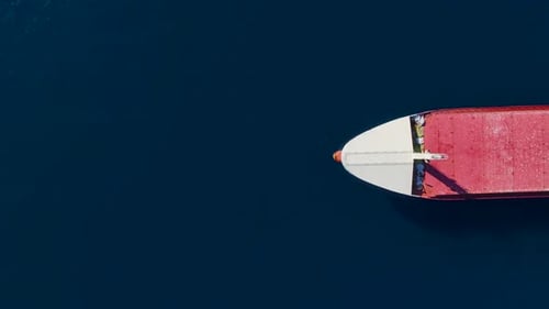 Aerial View Massive Cargo Ship Anchoring in the Dark Blue Sea at Dusk