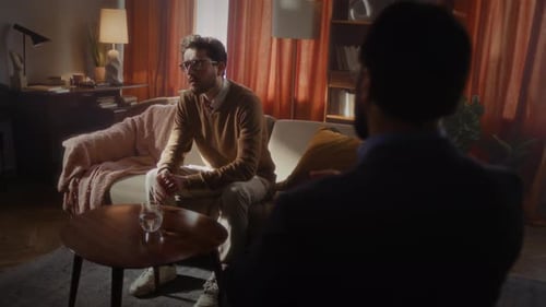 Man Talking During Therapy Session on Couch